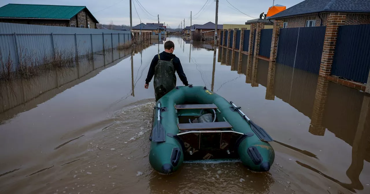 Russians flee 'very unusual' floods in boats clutching valuables, food, pets