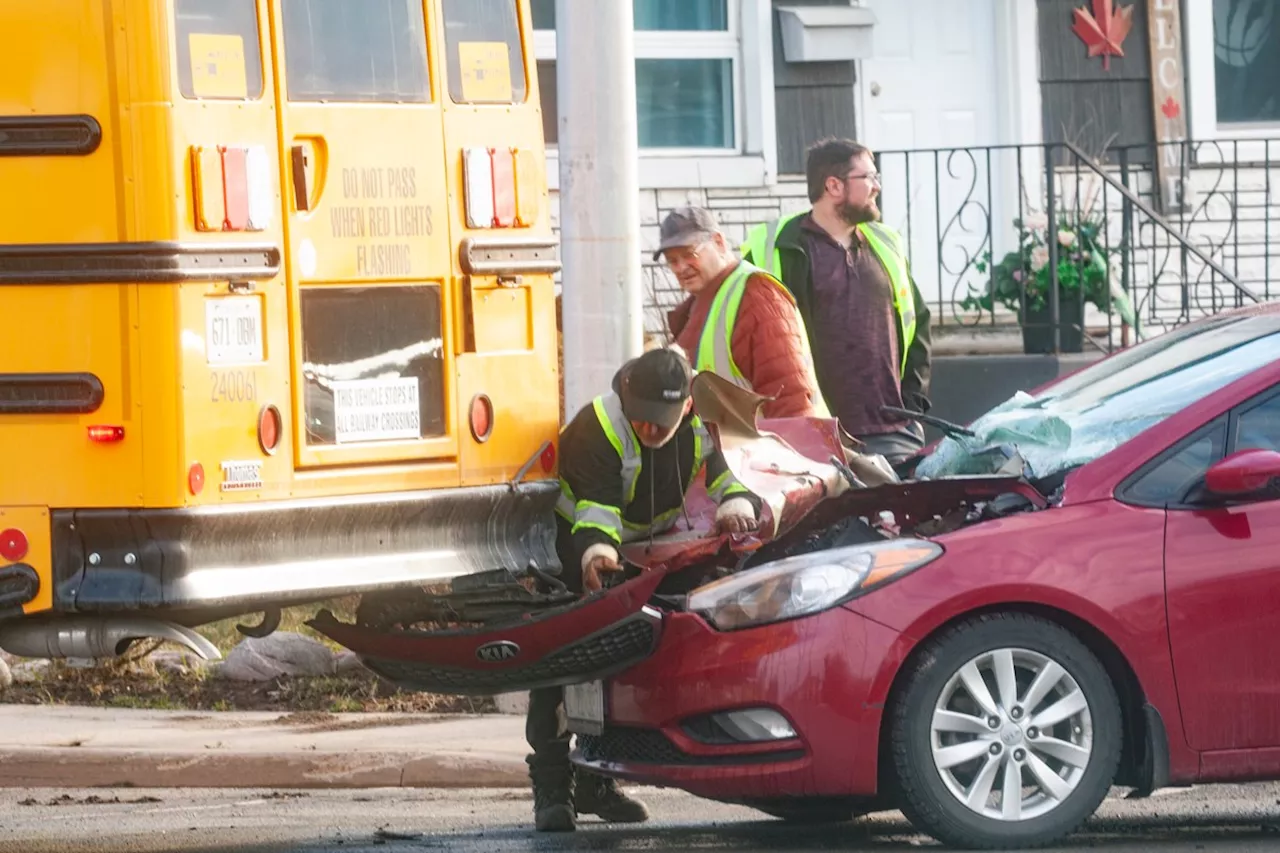 Driver charged after car crashes into school bus