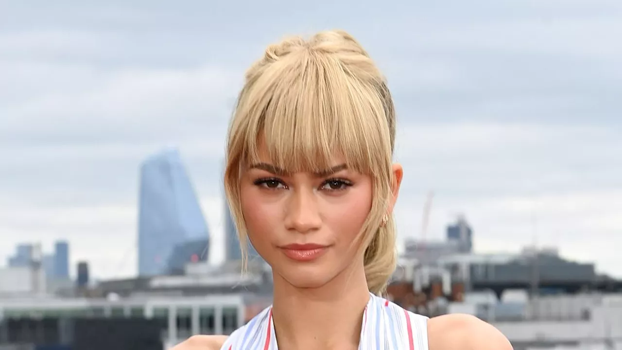 Zendaya shows off her incredible figure in a plunging striped waistcoat and a thigh-skimming skirt...
