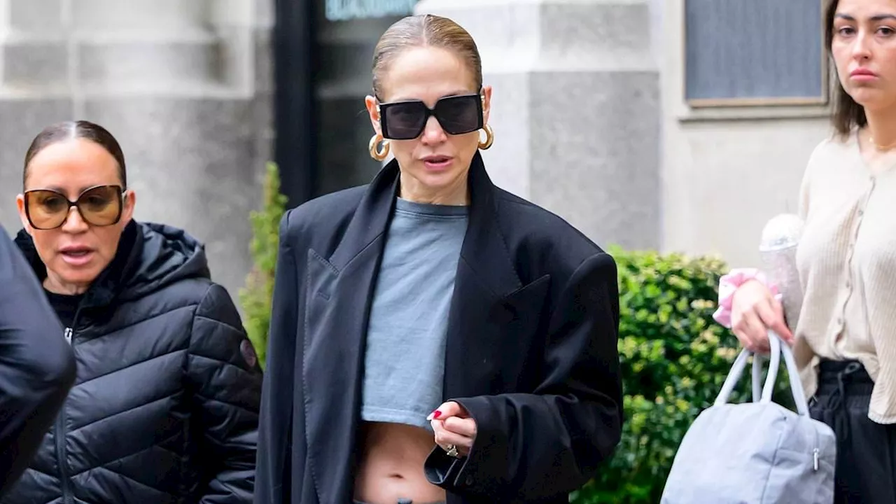 Jennifer Lopez bares her washboard abs in a tiny grey crop top in NYC