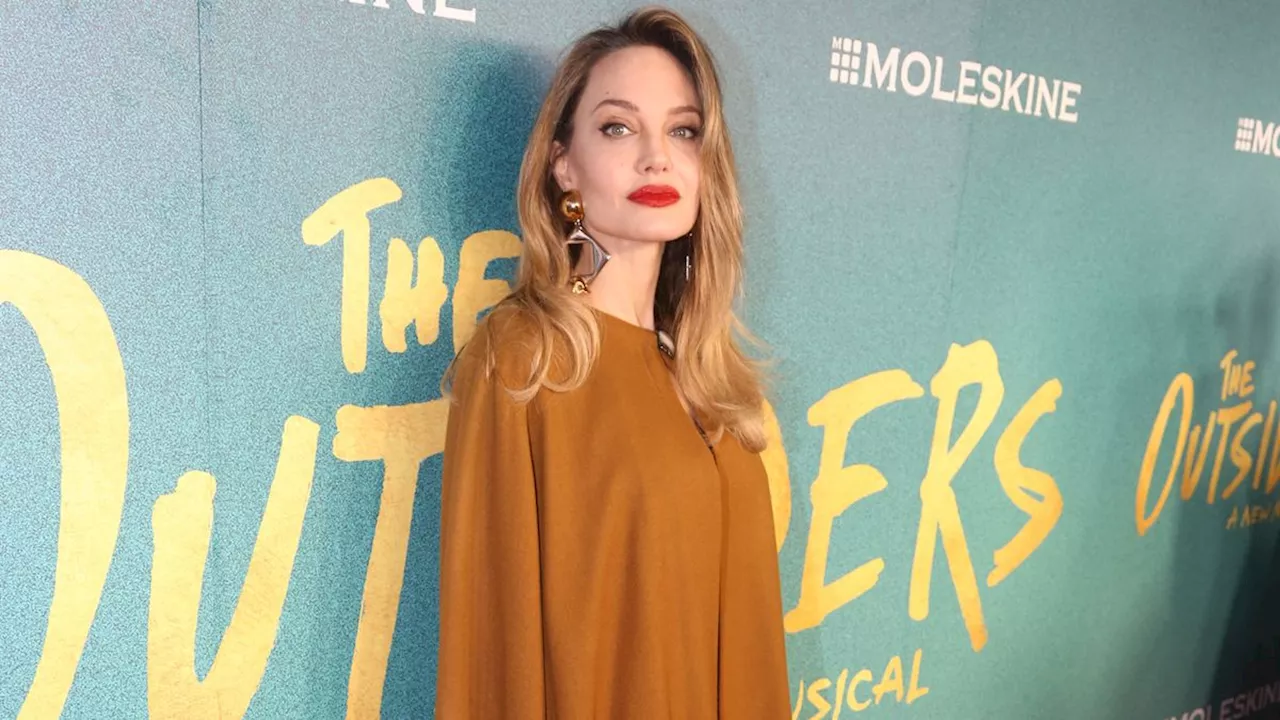 Angelina Jolie Wears a Golden Goddess Dress to the 'The Outsiders' Premiere