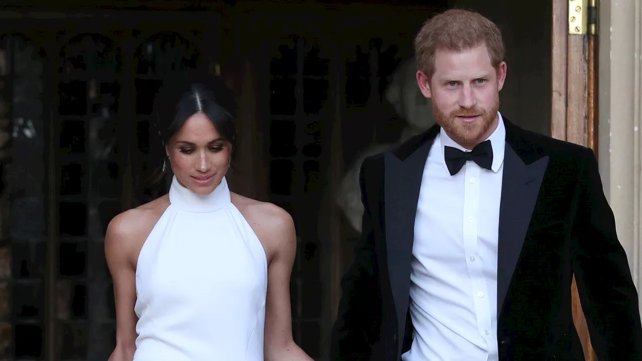 Meghan Markle Gives Prince Harry a Kiss While Wearing a Nod to Her Second Wedding Dress