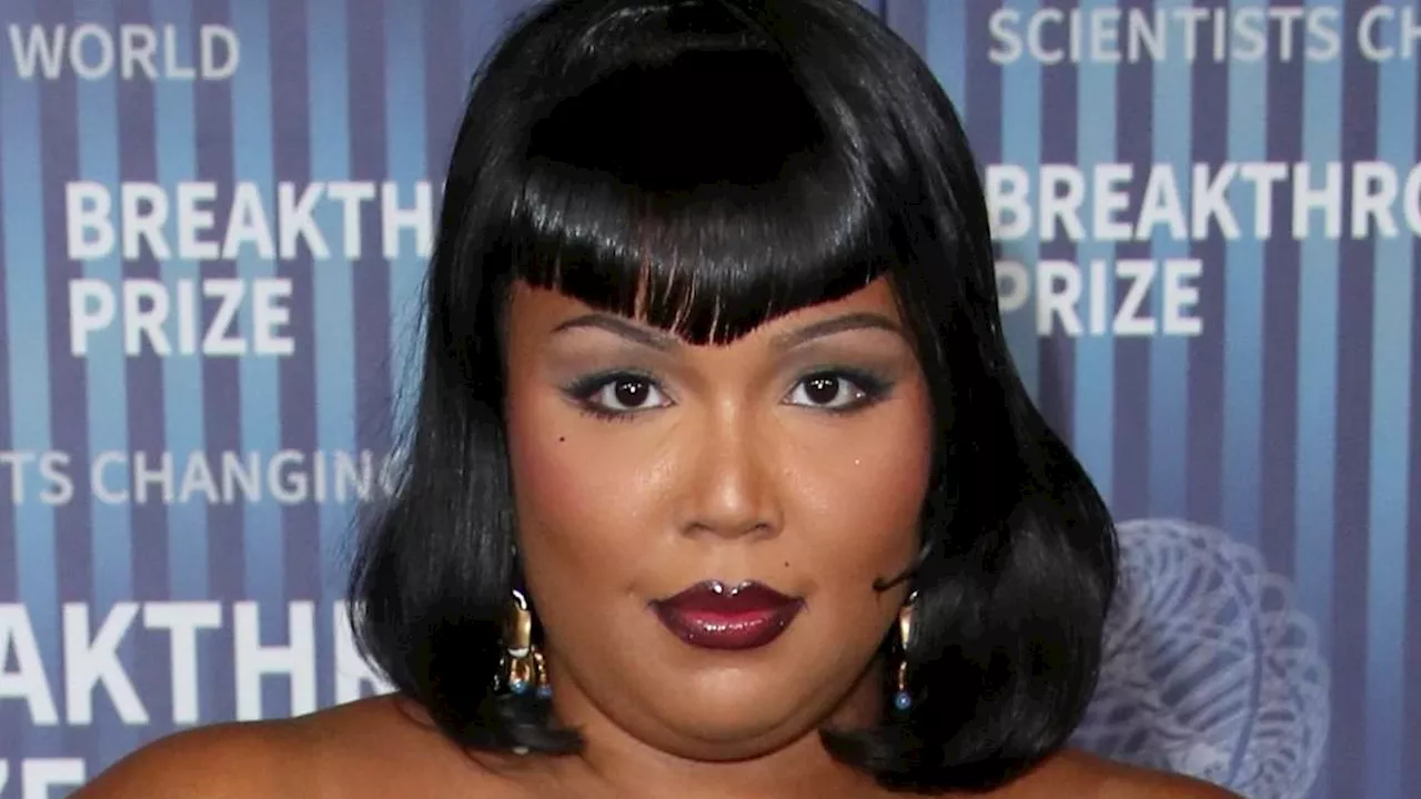 Lizzo exudes movie star glamour in dramatic black gown and Bettie Page bangs at 10th Annual...