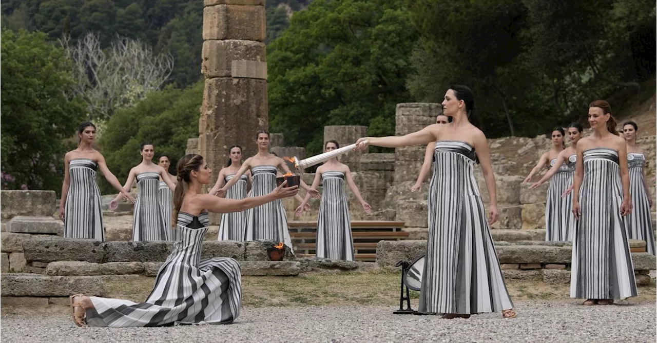 Despite weather glitch, the Paris Olympics flame is lit at the Greek cradle of ancient games