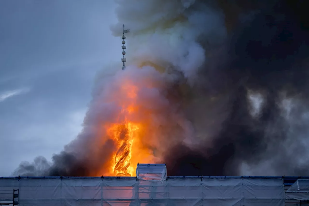 Iconic spire collapses as fire rages through 17th-century Old Stock Exchange in Copenhagen