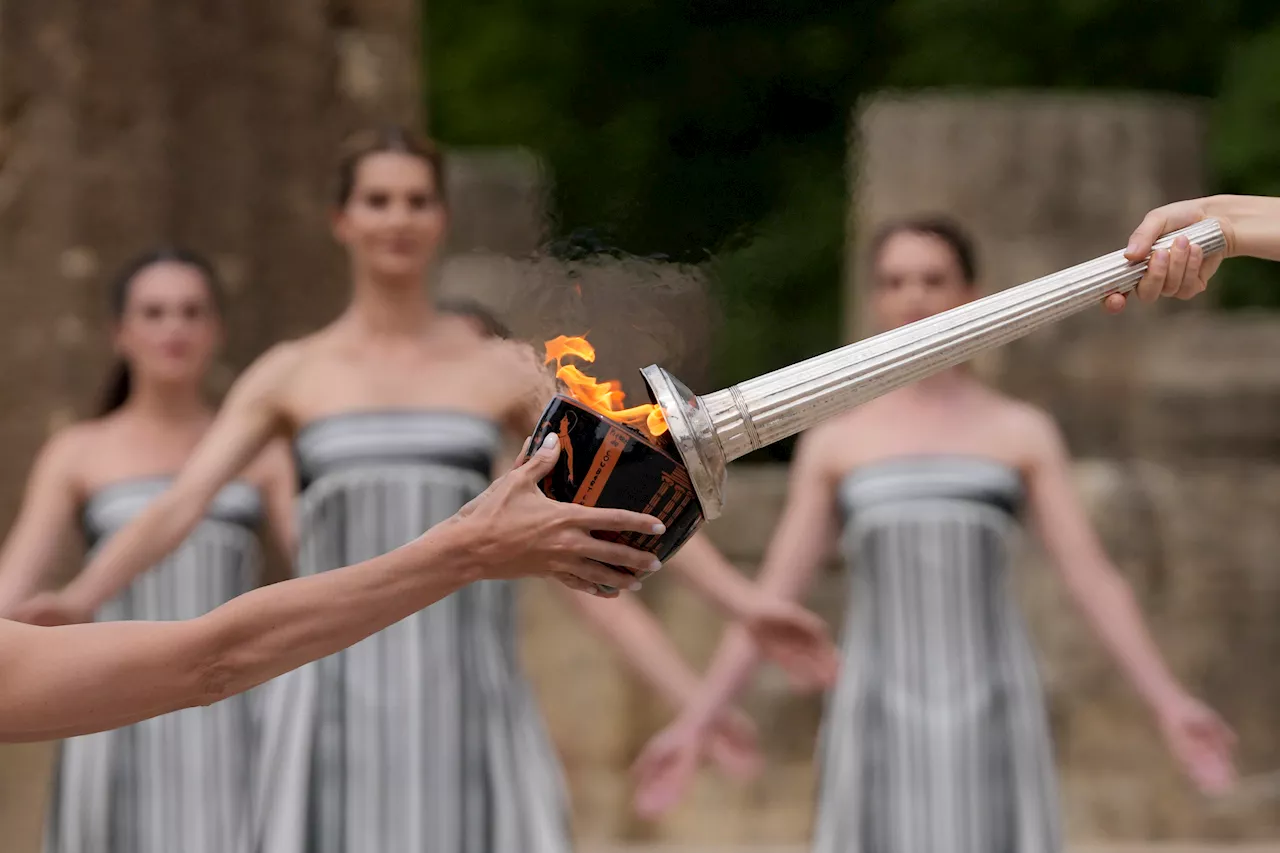 Despite weather glitch, the Paris Olympics flame is lit at the Greek cradle of ancient games