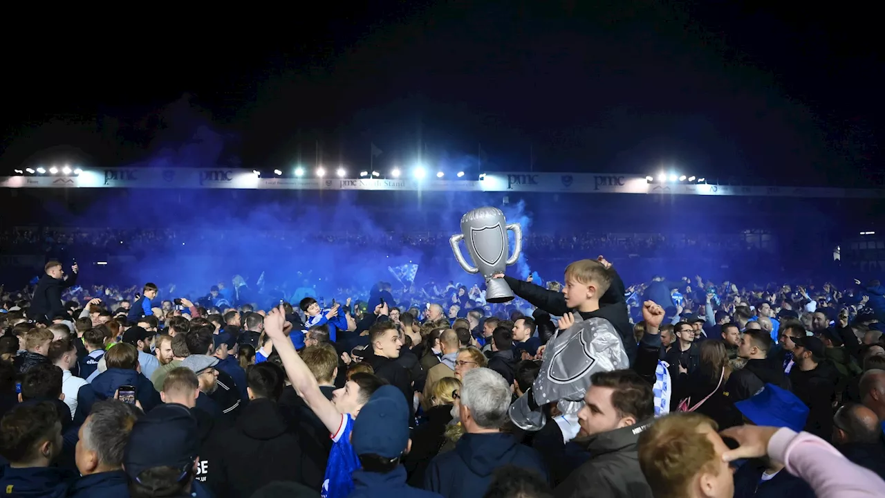 Portsmouth fans storm Fratton Park pitch with flares as supporters celebrate long-awaited return to...