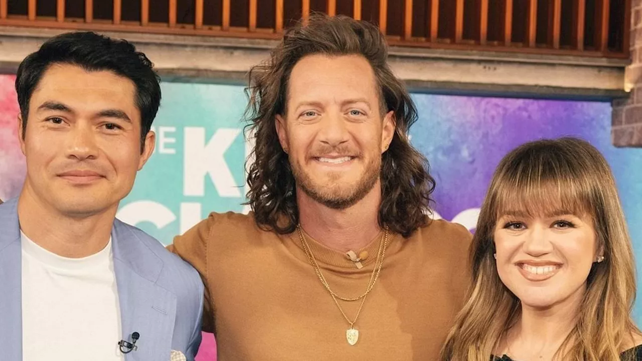 Kelly Clarkson stuns in black with Henry Golding and Tyler Hubbard