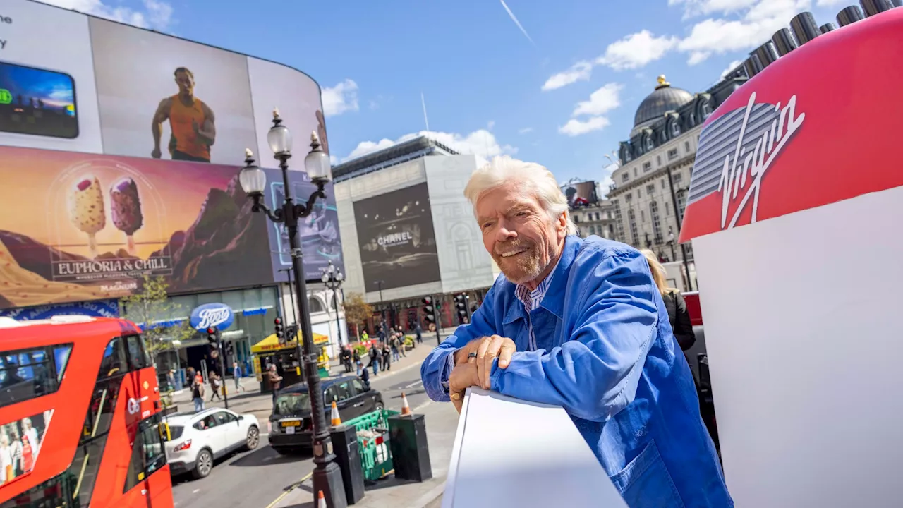 Sir Richard Branson spotted ‘sailing’ on bus-ship on London streets – handing out FREE cruise trips...