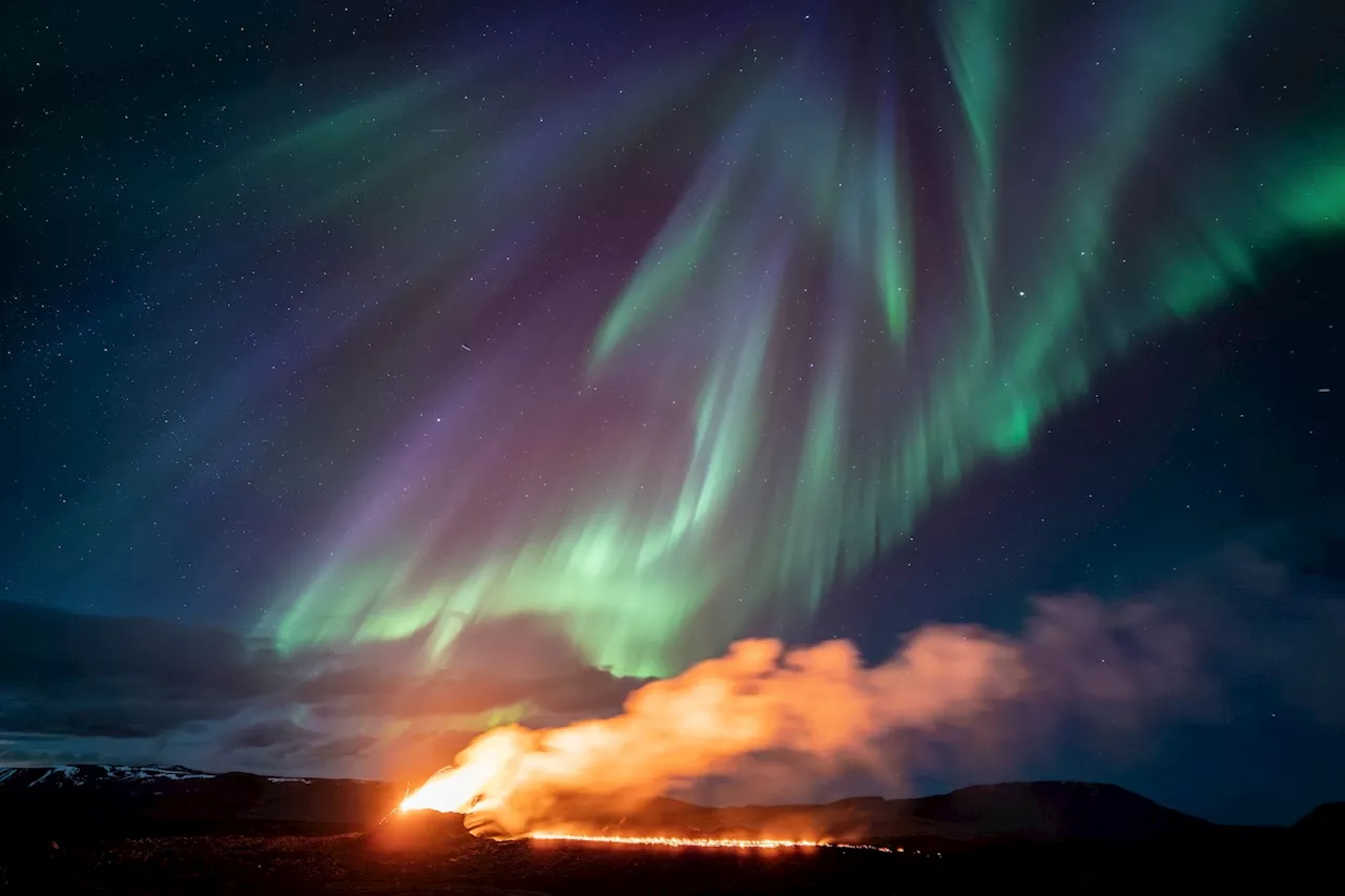 Watch an Icelandic volcano erupt below northern lights