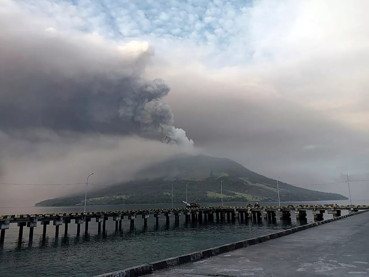 Indonesians leave homes near erupting volcano and airport closes due to ash danger