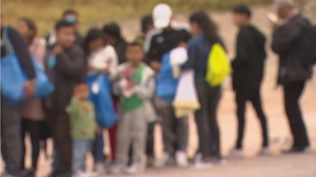 Large group of migrants, including children, cross US-Mexico border near San Ysidro