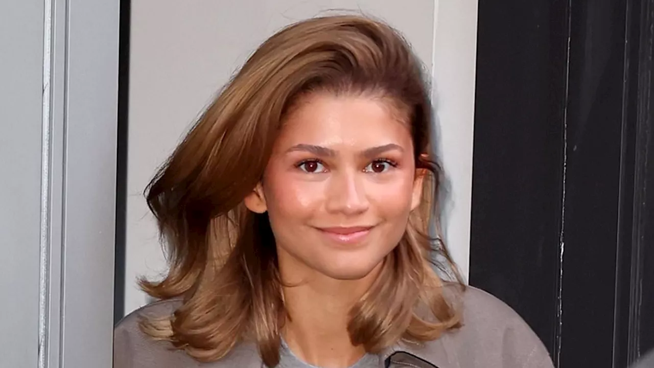 Zendaya puts on a casual display in oversize trench coat and baggy gray T-Shirt for special...