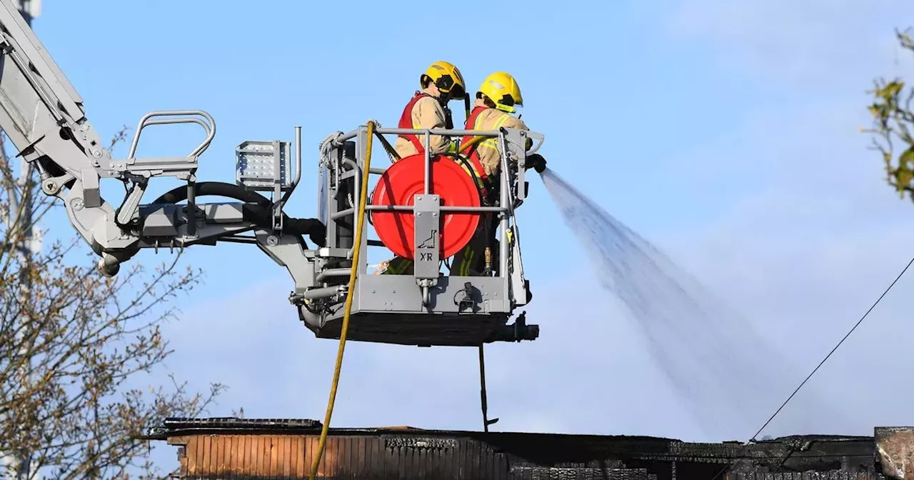 Road blocked as firefighters tackle building blaze