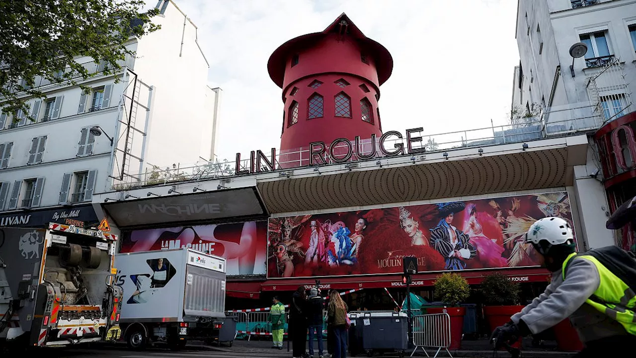 Moulin Rouge's famous windmill sails FALL OFF and crash onto street