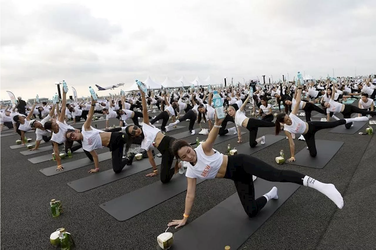 'Feel like a beautiful bird': Hundreds do yoga on Thai airport runway