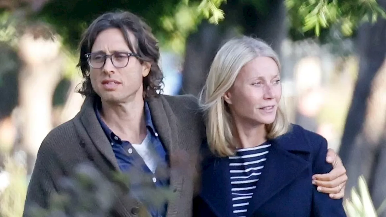 Gwyneth Paltrow and husband Brad Falchuk put on an affectionate display as they wrap their arms...