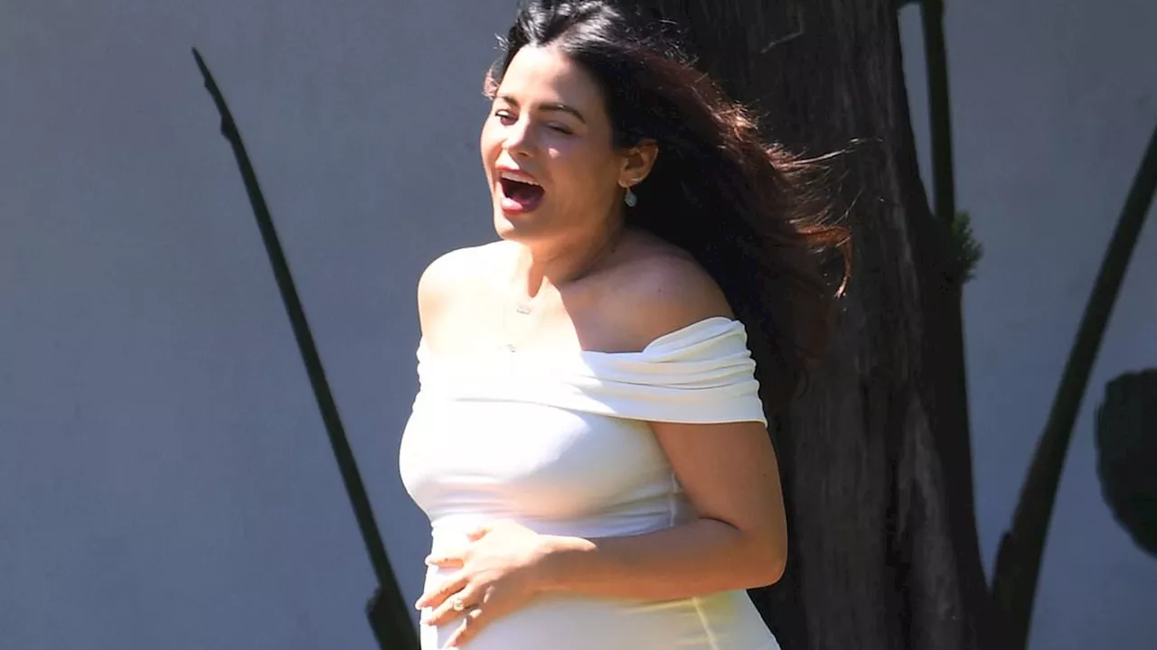 Pregnant Jenna Dewan beams while showcasing substantial bump in white dress at baby shower in Los...