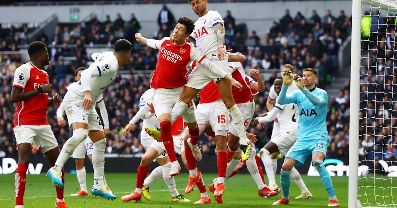 Arsenal hang on to beat Spurs, maintain lead at top