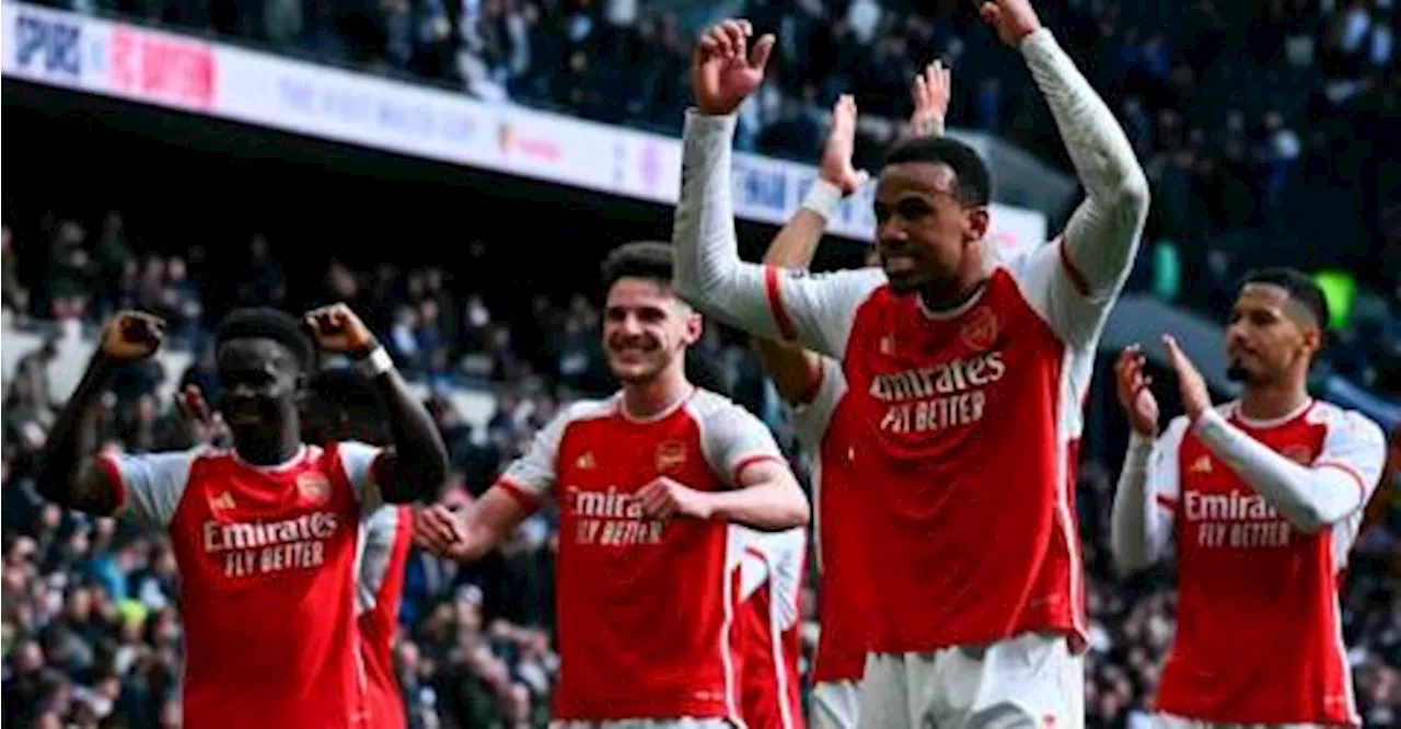 Arsenal survive Spurs fightback to boost title charge