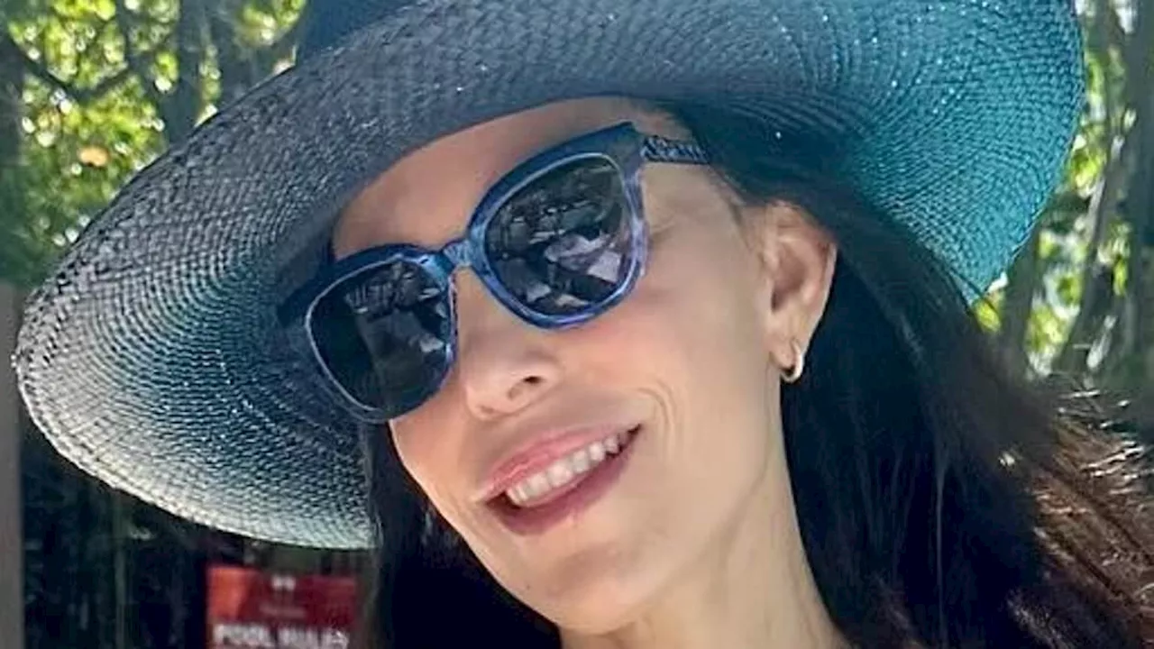 Bethenny Frankel, 53, showcases her toned figure in stylish blue bikini while indulging in cocktails...