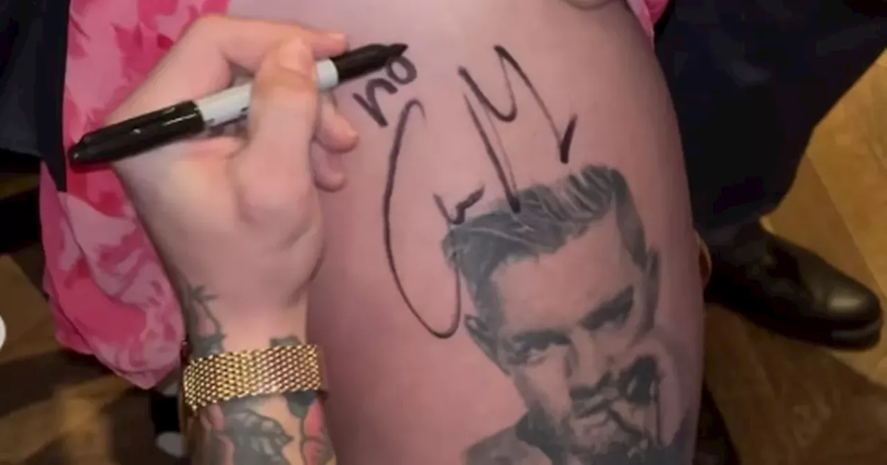 Conor McGregor signs tattoo of himself on woman's leg in his pub