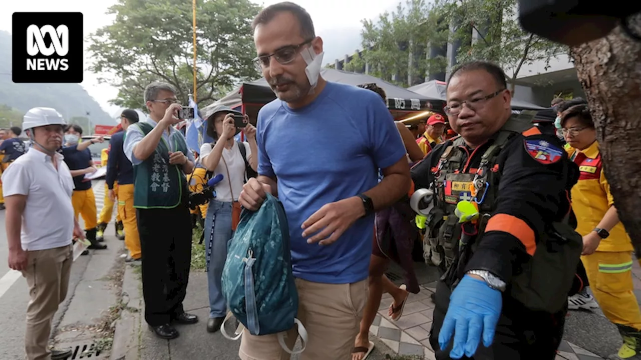 Two Australians missing as Taiwanese rescuers try to reach scores trapped in tunnels after quake