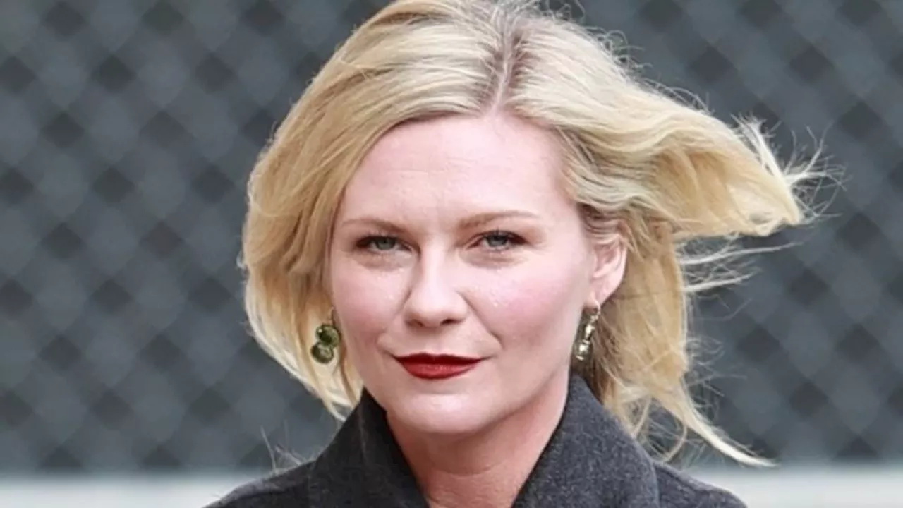 Kirsten Dunst bundles up in a cozy gray coat as she arrives at Hollywood's El Capitan Theatre ahead...