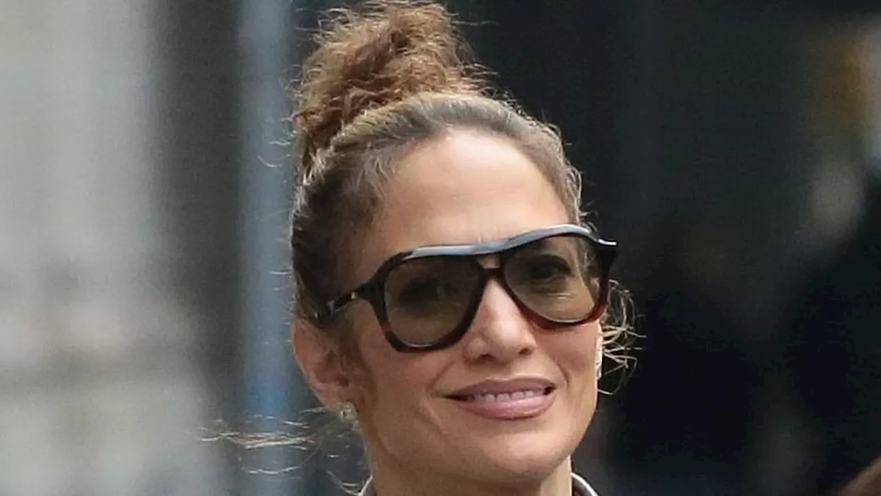 Jennifer Lopez is effortlessly chic in a stylish grey coat and sculpted leggings as she enjoys an...