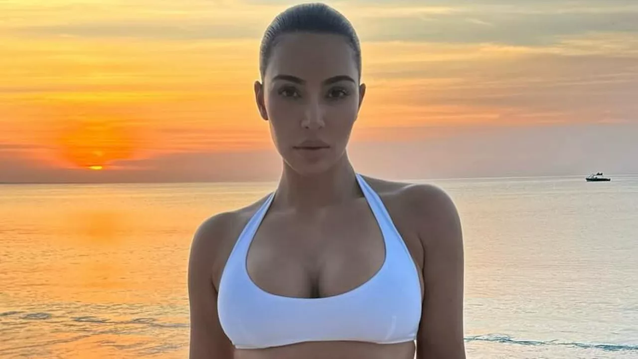 Kim Kardashian bares her sculpted beach body in Miu Miu bikini and sarong after going jet-skiing...