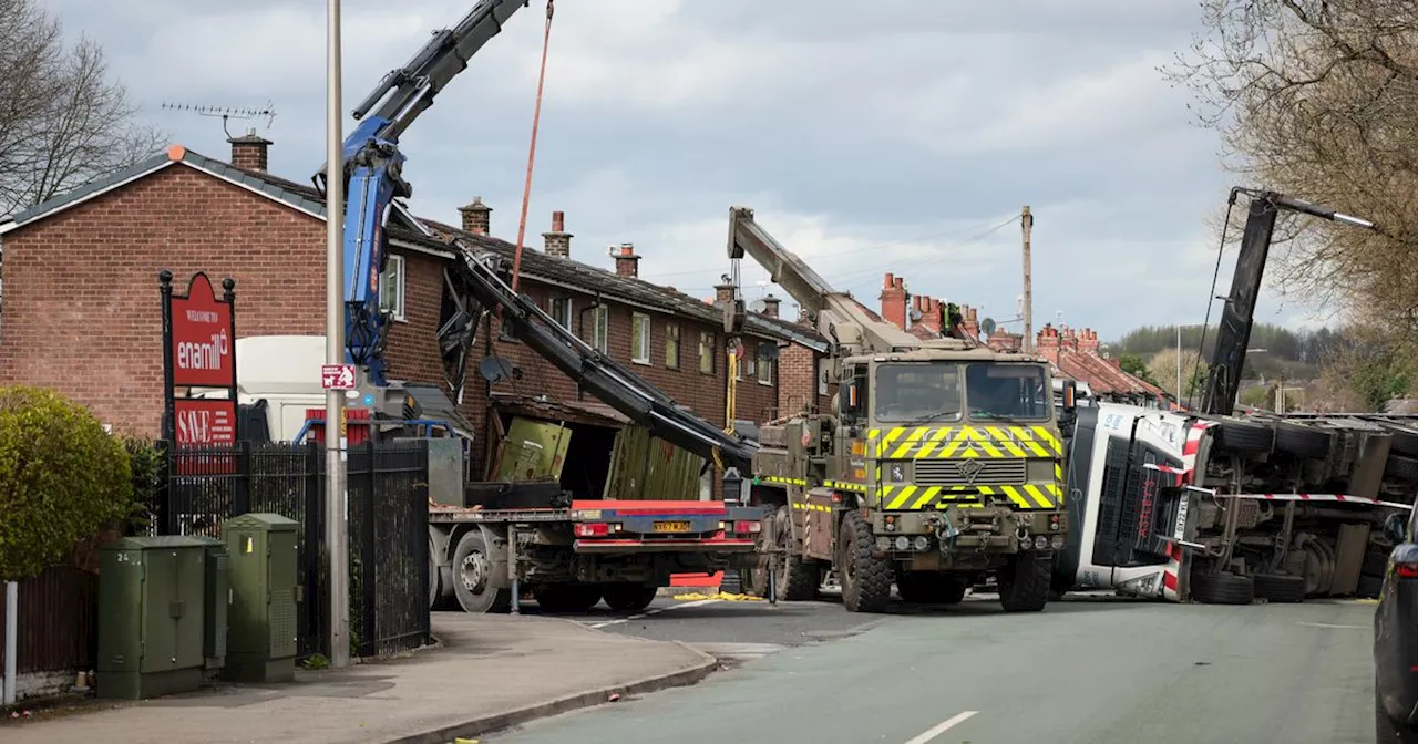 LIVE: Crane topples over in Wigan and 'slices through house'