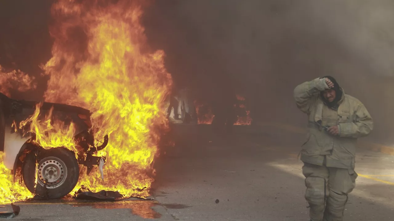 Protesters in southern Mexico set state government building afire and torch a dozen vehicles