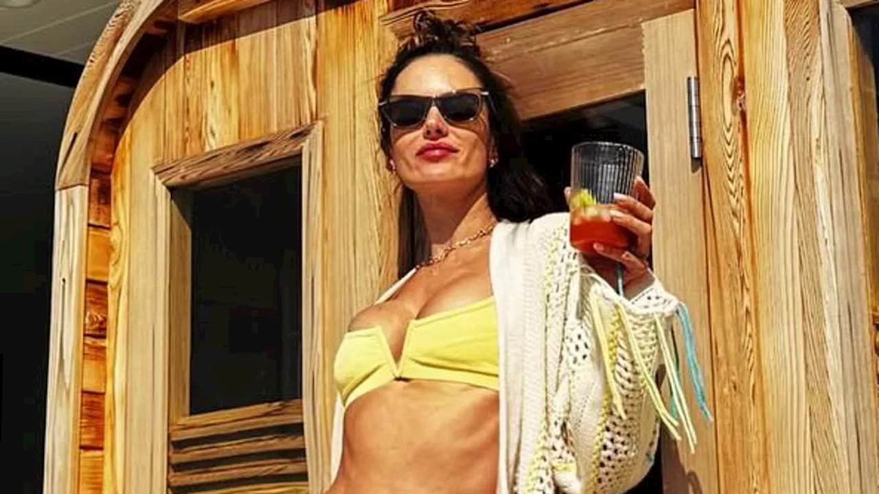 Alessandra Ambrosio, 42, looks as fit as ever while modeling a neon yellow bikini in sunny Southern...