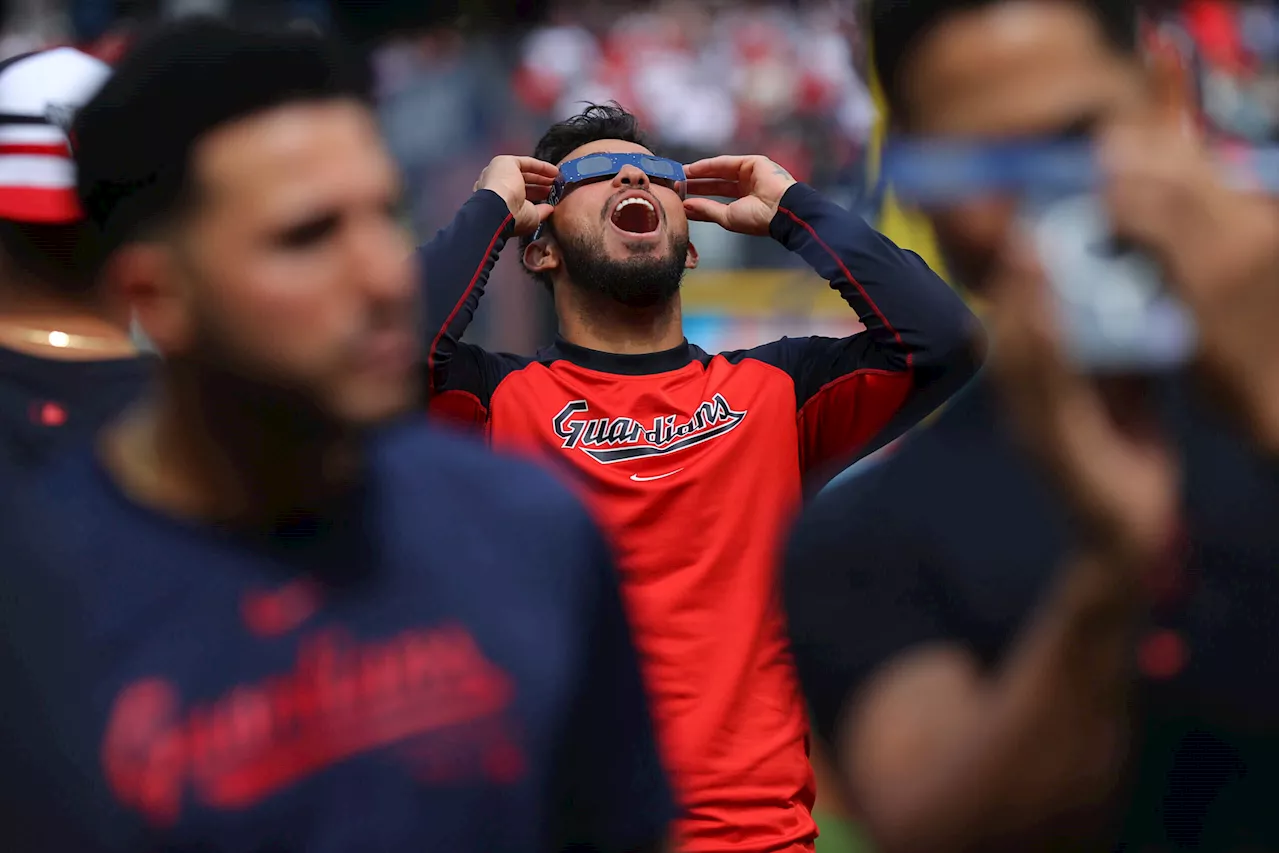 Photos: Solar eclipse seen at Guardians-White Sox, Reds-Brewers games and Masters practice