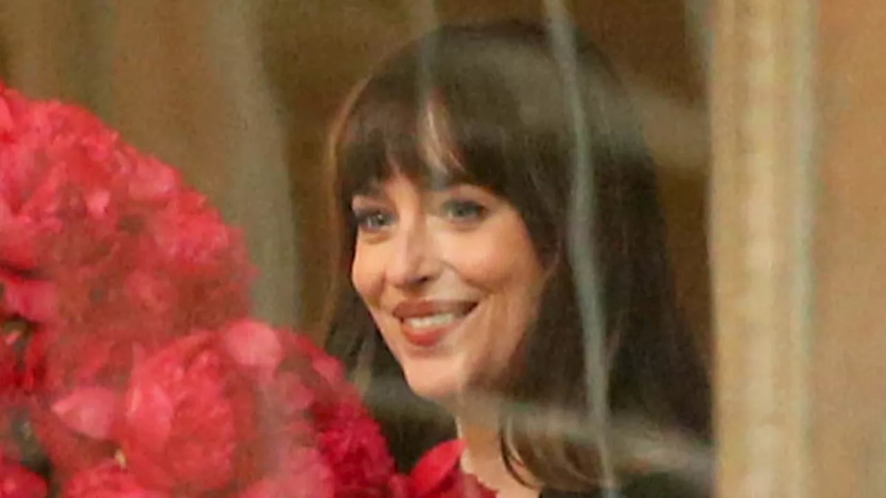 Dakota Johnson looks smitten as she receives MASSIVE bouquet of flowers from hunky Pedro Pascal......