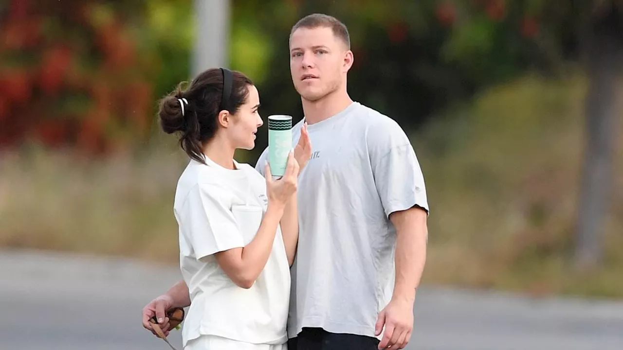 Olivia Culpo and fiancé Christian McCaffrey pictured walking hand in hand as the countdown to their...