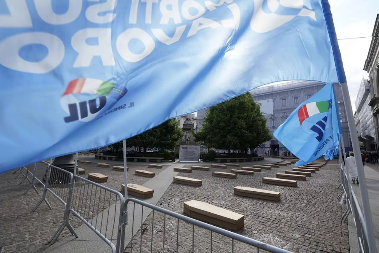 Mock coffins fill a square in Milan in a protest over workplace safety in Italy