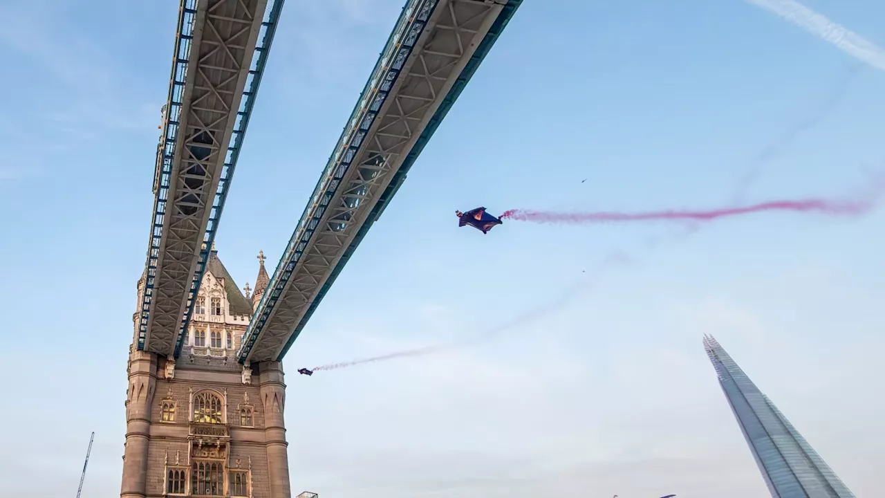 Skydrivers in wingsuits fly through Tower Bridge after jumping from helicopter