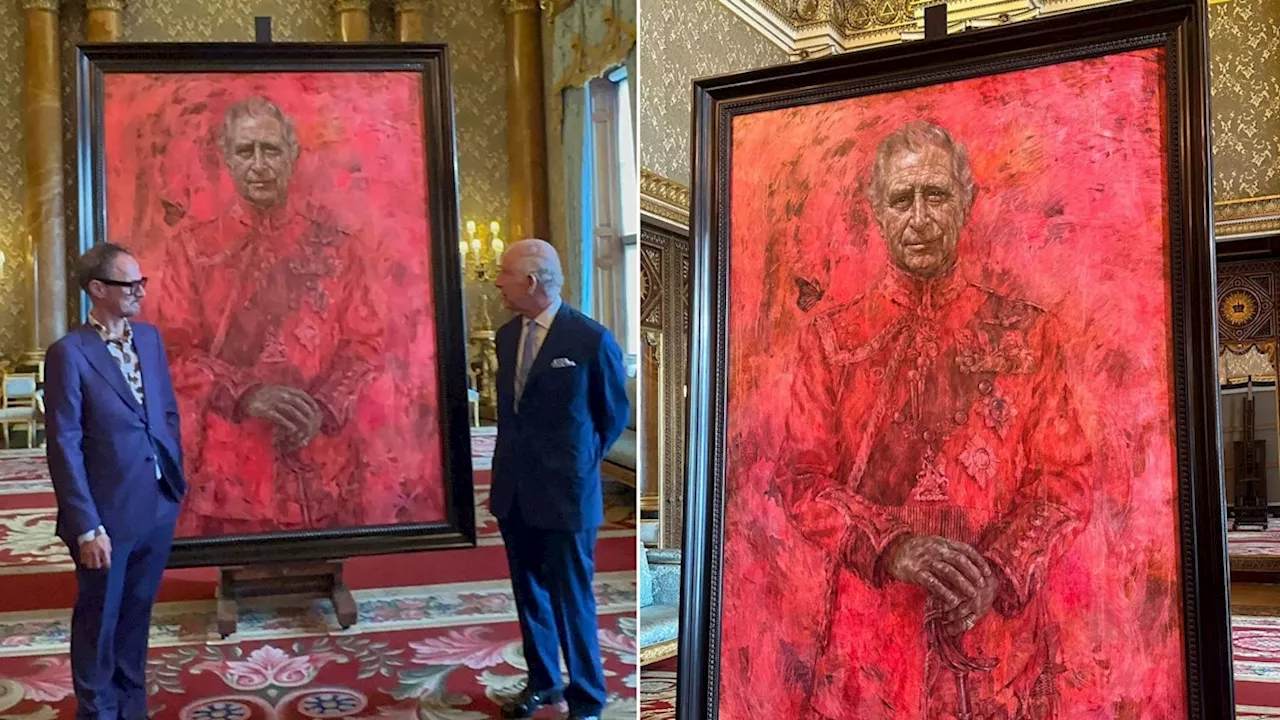 King Charles reacts as he unveils his first official portrait since coronation