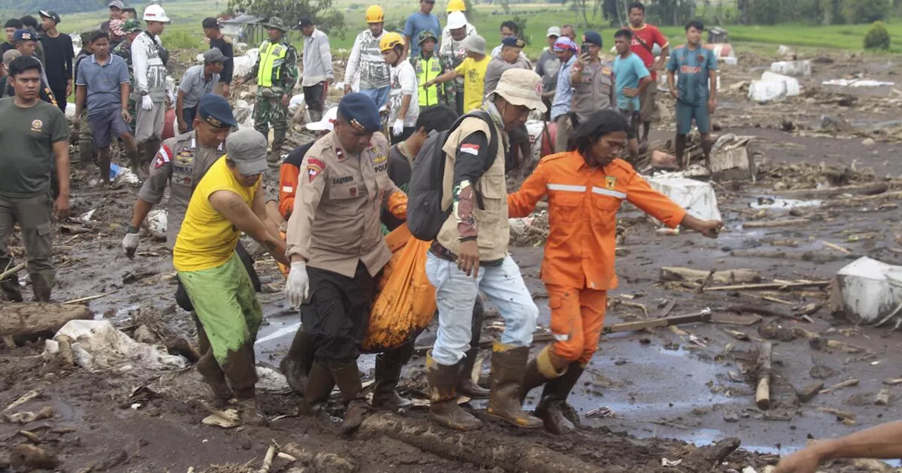 Indonesian rescuers search through rivers and rubble after flash floods that killed at least 50