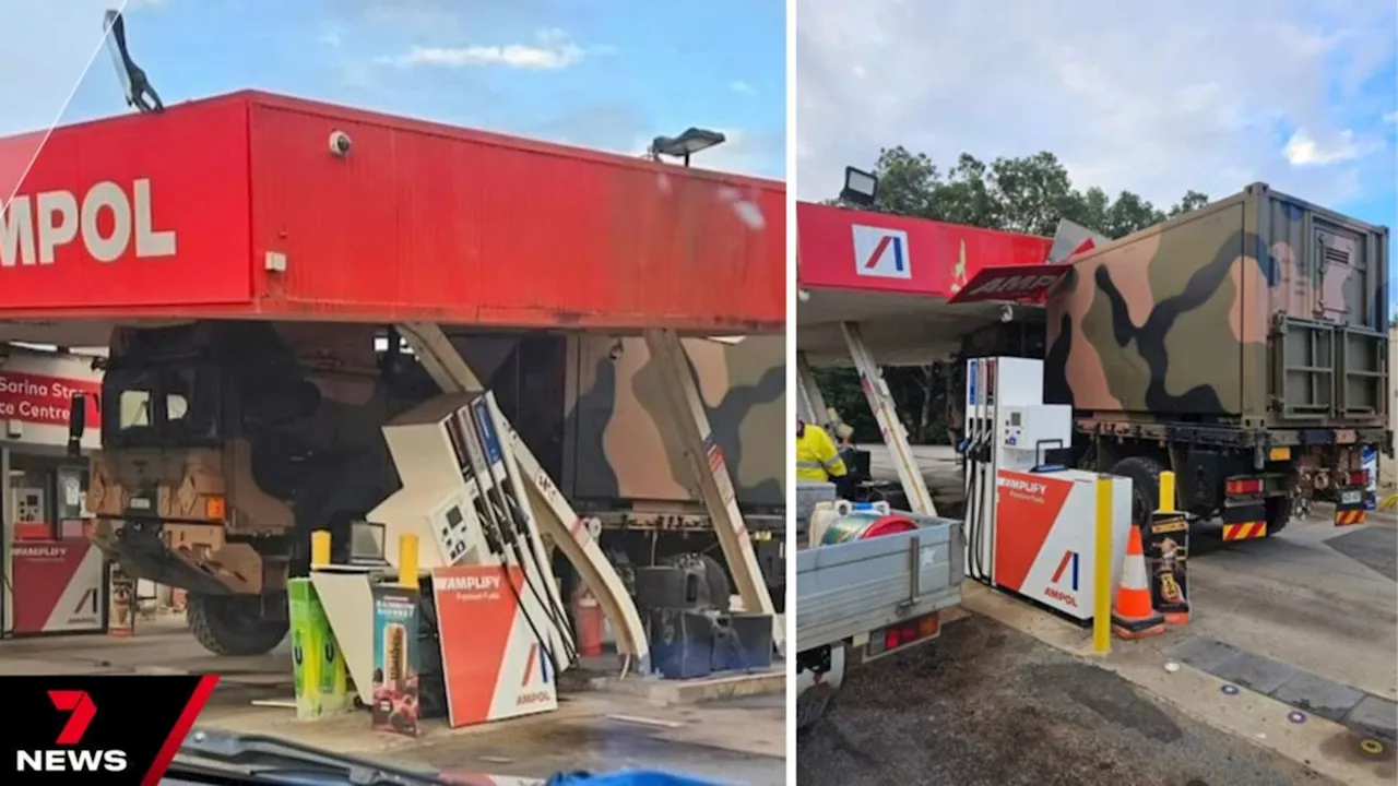 Australian Defence Force working to remove truck after crash causes extensive damage to Queensland petrol station