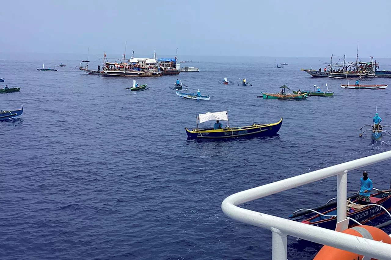 Filipino activists and fishermen sail in 100-boat flotilla to disputed shoal guarded by China