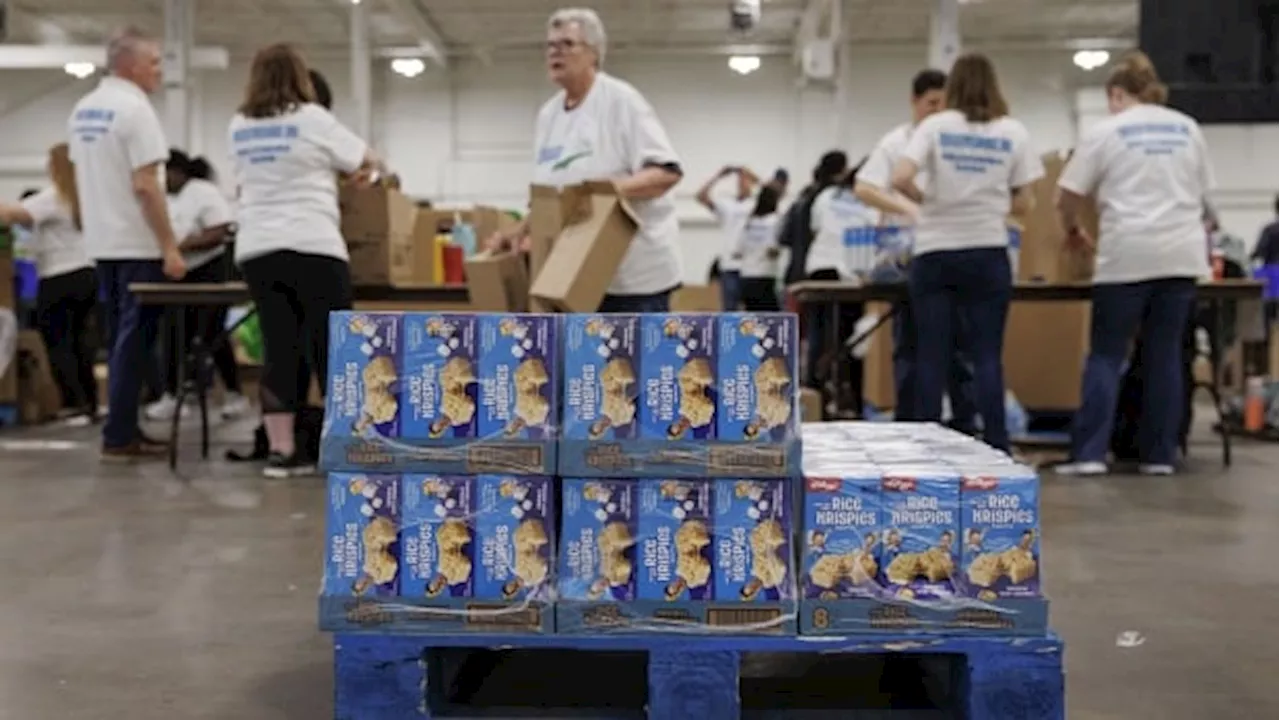 Volunteers pack healthy food for kids in need this summer