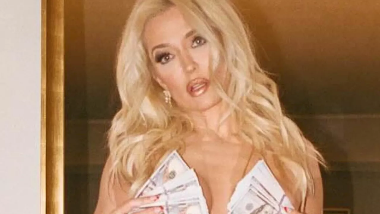 Erika Jayne, 52, goes nude and flashes cleavage while fanning $100 bills over her chest for...