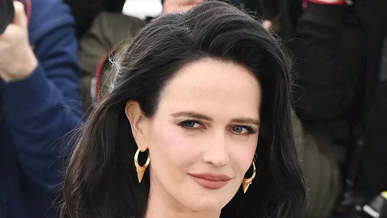 Eva Green shows off her hourglass figure in a black off-the-shoulder shirt and a stylish skirt as...