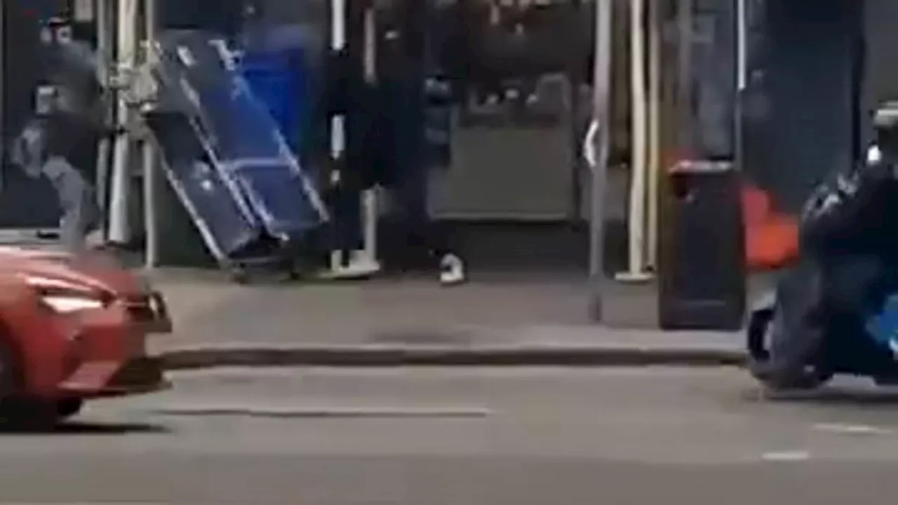 Moment machete-wielding thug tries to attack another youth outside Greggs on busy London street...