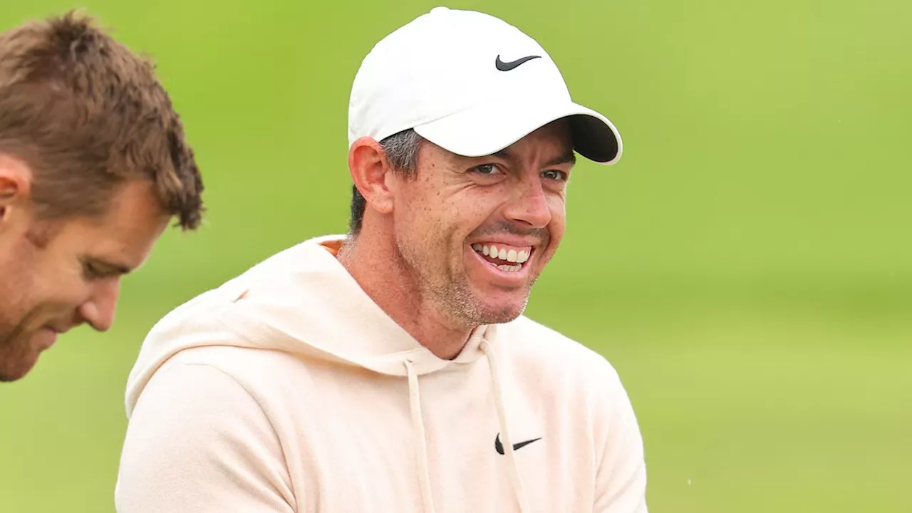 Rory McIlroy can't hide his joy as he takes to the course hours after revealing he is divorcing wife...