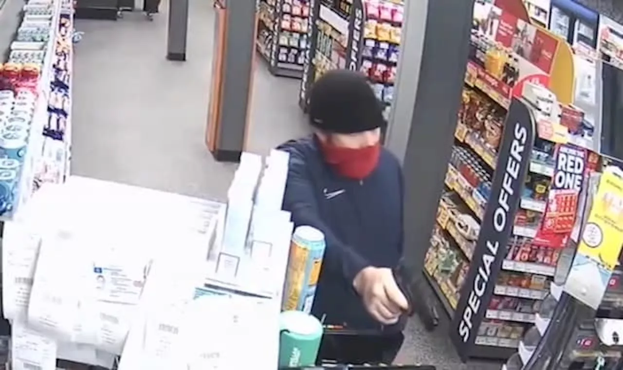 Robbers armed with imitation gun and knife raid service station in CCTV footage