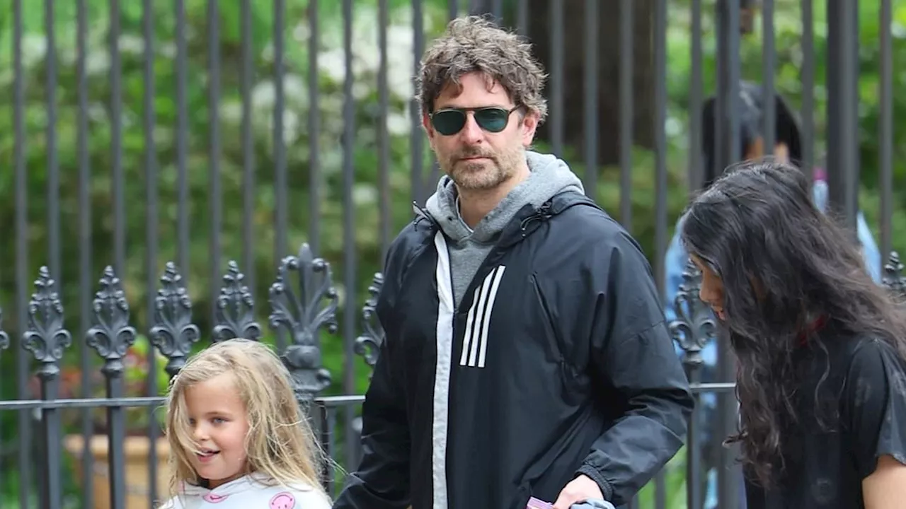 Bradley Cooper holds his daughter Lea's hand while taking her for a walk in New York City