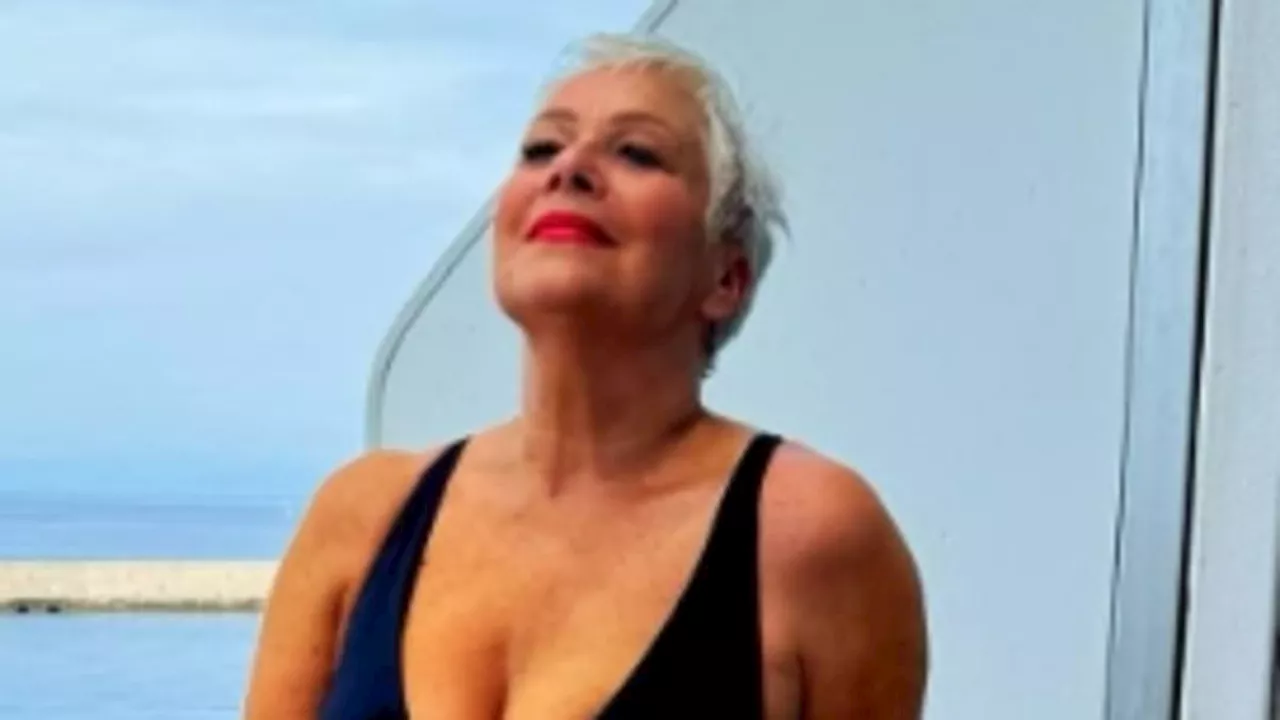 Denise Welch, 65, looks sensational as she poses in a plunging black swimsuit during sun-soaked...